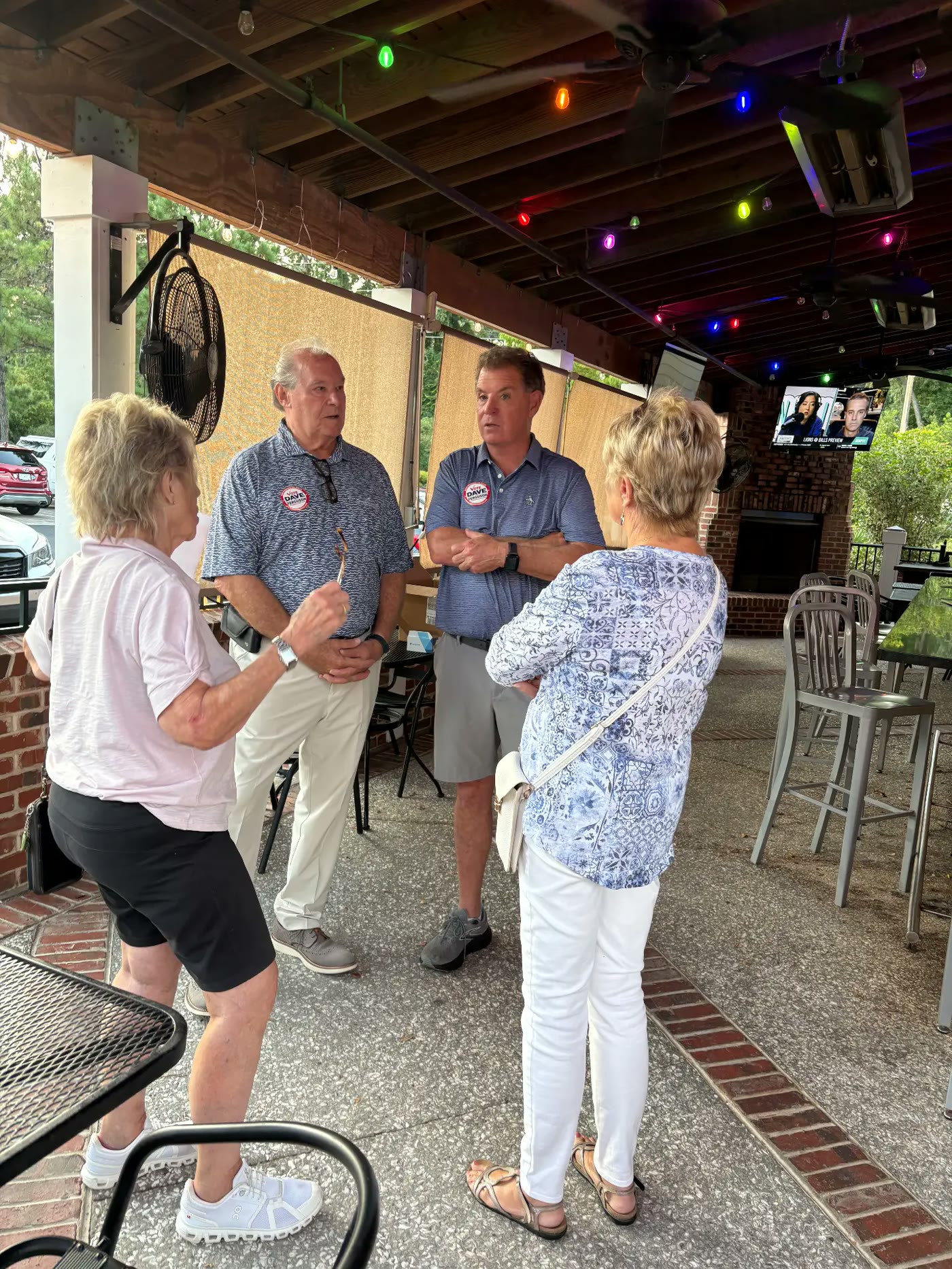 Dave Ferguson talking with residents under the patio lights