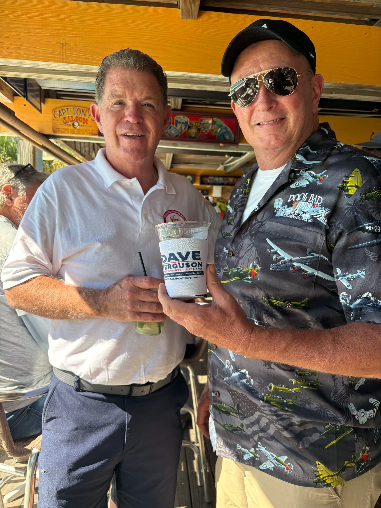 Dave Ferguson with a supporter holding a Dave Ferguson koozie